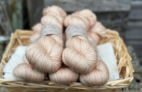 Five skeins of peachy beige yarn