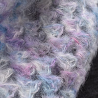Close up detail of a fluffy granny stripe cowl in variegated colours including purple, pink and cream
