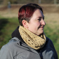 Victoria wearing a grey coat and a sand coloured crochet cluster cowl