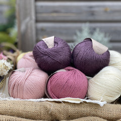 Eight balls of Milburn 4ply in shades of pink, purple and cream