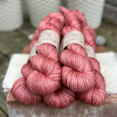 Five skeins of pink yarn