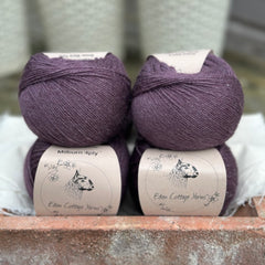 Balls of dark purple yarn