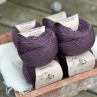 Balls of dark purple yarn