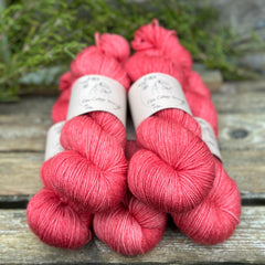Five skeins of rich pink yarn