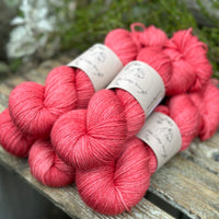 Five skeins of rich pink yarn