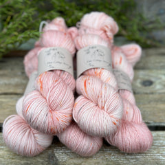 Five skeins of pink yarn with orange splashes 