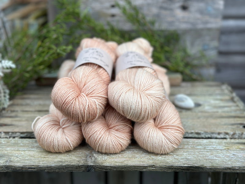 Five skeins of pale orange yarn