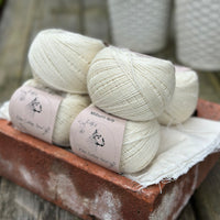 Balls of natural cream coloured yarn