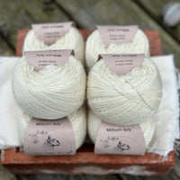 Balls of natural cream coloured yarn
