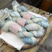 Three skeins of variegated blue and green yarn