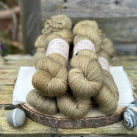 Five skeins of greenish brown yarn