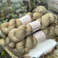 Five skeins of greenish brown yarn