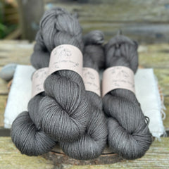 Four skeins of dark grey yarn