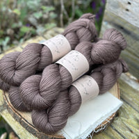 Five skeins of dark brown yarn