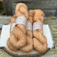 Four skeins of golden brown yarn