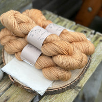 Four skeins of golden brown yarn