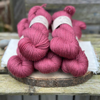 Five skeins of purpley red yarn