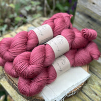 Five skeins of purpley red yarn