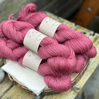 Five skeins of purpley red yarn