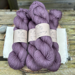 Four skeins of purple yarn