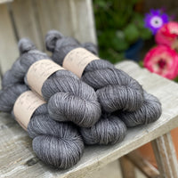 Five skeins of dark grey yarn