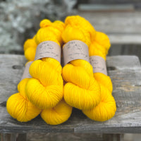 Five skeins of bright yellow yarn