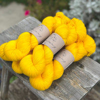 Five skeins of bright yellow yarn