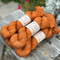 Five skeins of orangey brown yarn