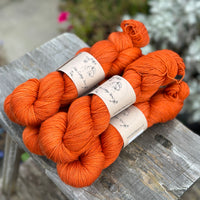 Five skeins of dark orange yarn