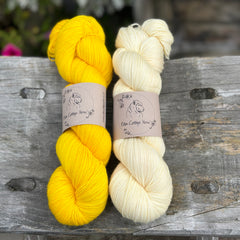 Two skeins of yarn - one rich yellow and one creamy yellow yarn