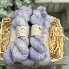 Five skeins of pale purple yarn