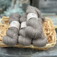 Four skeins of grey-brown yarn