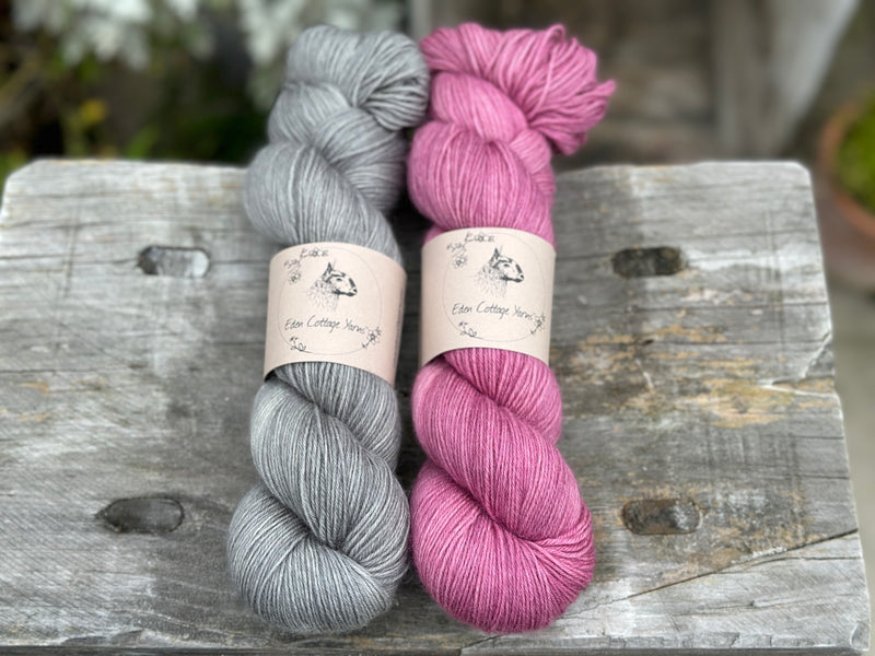Two skeins of yarn - one grey, one pinky purple