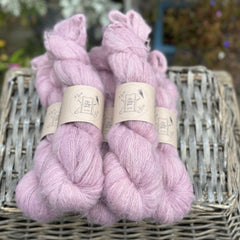 Five skeins of pale purpley pink yarn