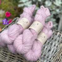 Five skeins of pale purpley pink yarn