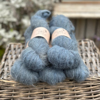Five skeins of dark blue fluffy yarn