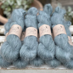 9 skeins of fluffy blue-green yarn