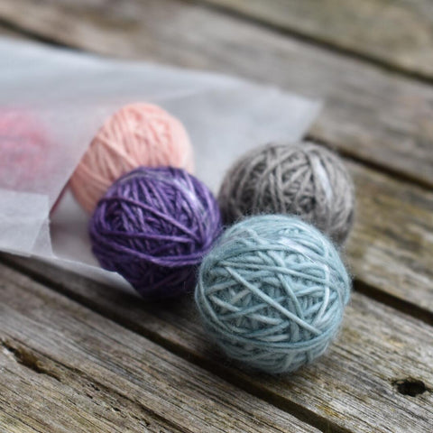 Five Yarnlings spilling out of a glassine bag