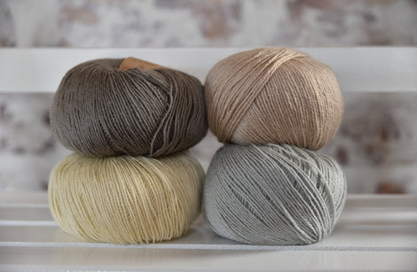 Four balls of Milburn in shades of grey, cream, beige and pale blue