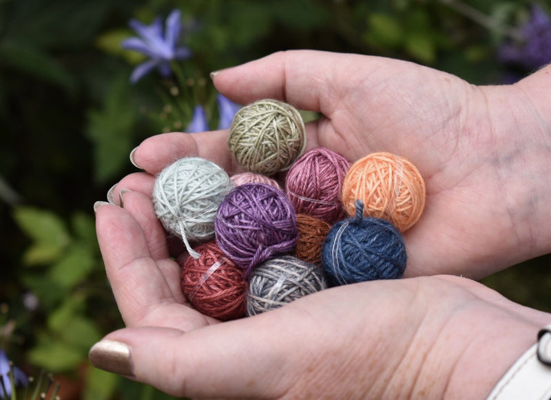 A pair of hands holding a selection of Yarnlings