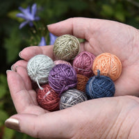 A pair of hands holding a selection of Yarnlings