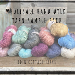 A pile of yarns in different bases and colours. "Wholesale Hand Dyed Yarn Sample Pack" is overlaid in black text at the top of the image. "Eden Cottage Yarns" is overlaid at the bottom of the image.