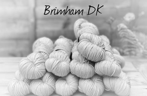 Black and white image of skeins of yarn with "Brimham DK" overlaid in black text