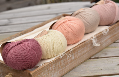 Five balls of Milburn 4ply in shades of pink, beige and cream