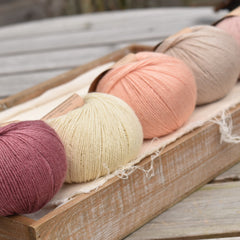 Five balls of Milburn 4ply in shades of pink, beige and cream