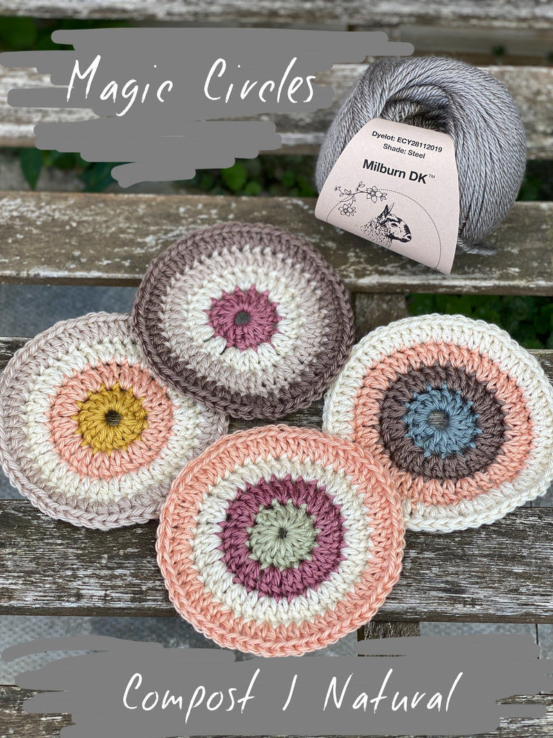 Four crocheted circles are sat on a wooden bench, in colours of brown, beige, peach, pink, cream, yellow, and sage green. They are next to a steely grey ball of Milburn DK yarn. 