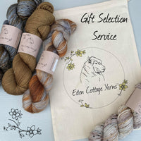A project bag with four skeins of yarn. "Gift Selection Service" is overlaid in black text