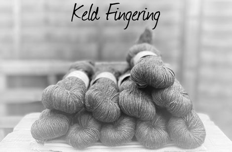 Black and white image of skeins of yarn with "Keld Fingering" overlaid in black text