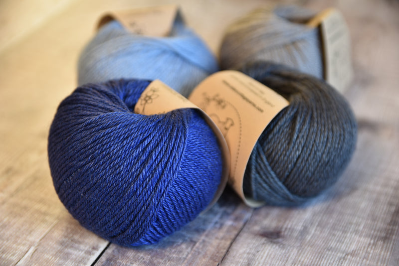 Four balls of Milburn in shades of blue and grey