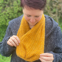 Victoria wearing an orange Swainby Cowl over a grey jacket